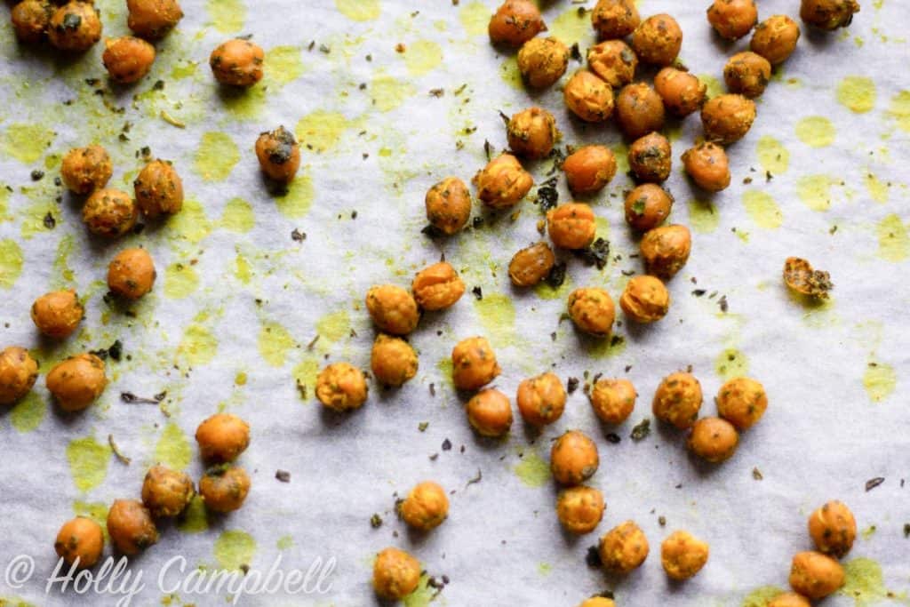 close up of curry roasted chickpeas on a baking sheet, golden and crunchy